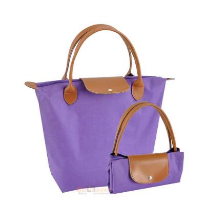Bolsa feminina lilás com alças em sintético e aba com botão de pressão - 1281140